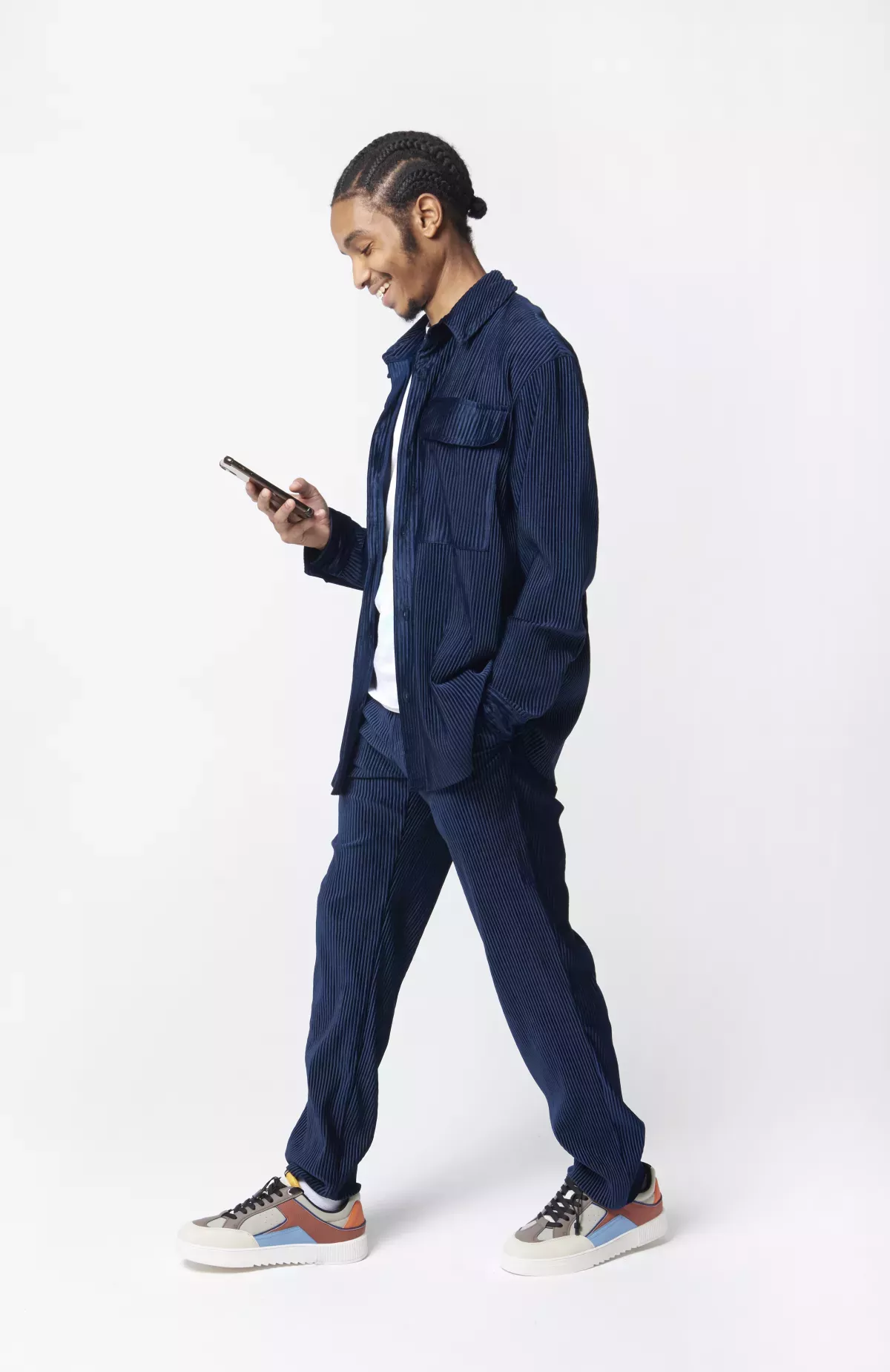 GettyImages-1355084638.jpg person walking using cell phone