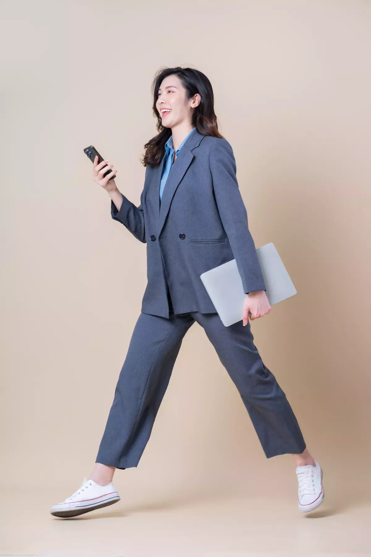 GettyImages-1390005741.jpg person walking using cell phone holding clipboard