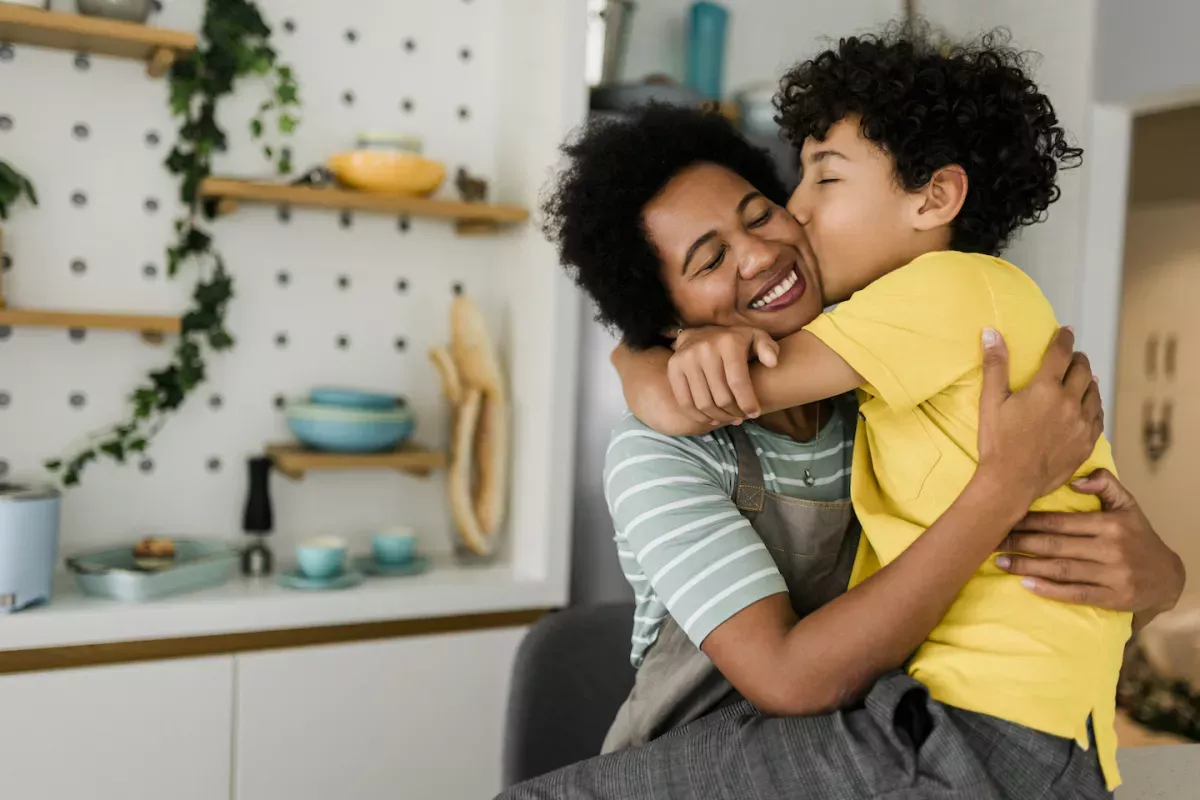 GettyImages-1456021684.jpg Son kissing his mother on the cheek