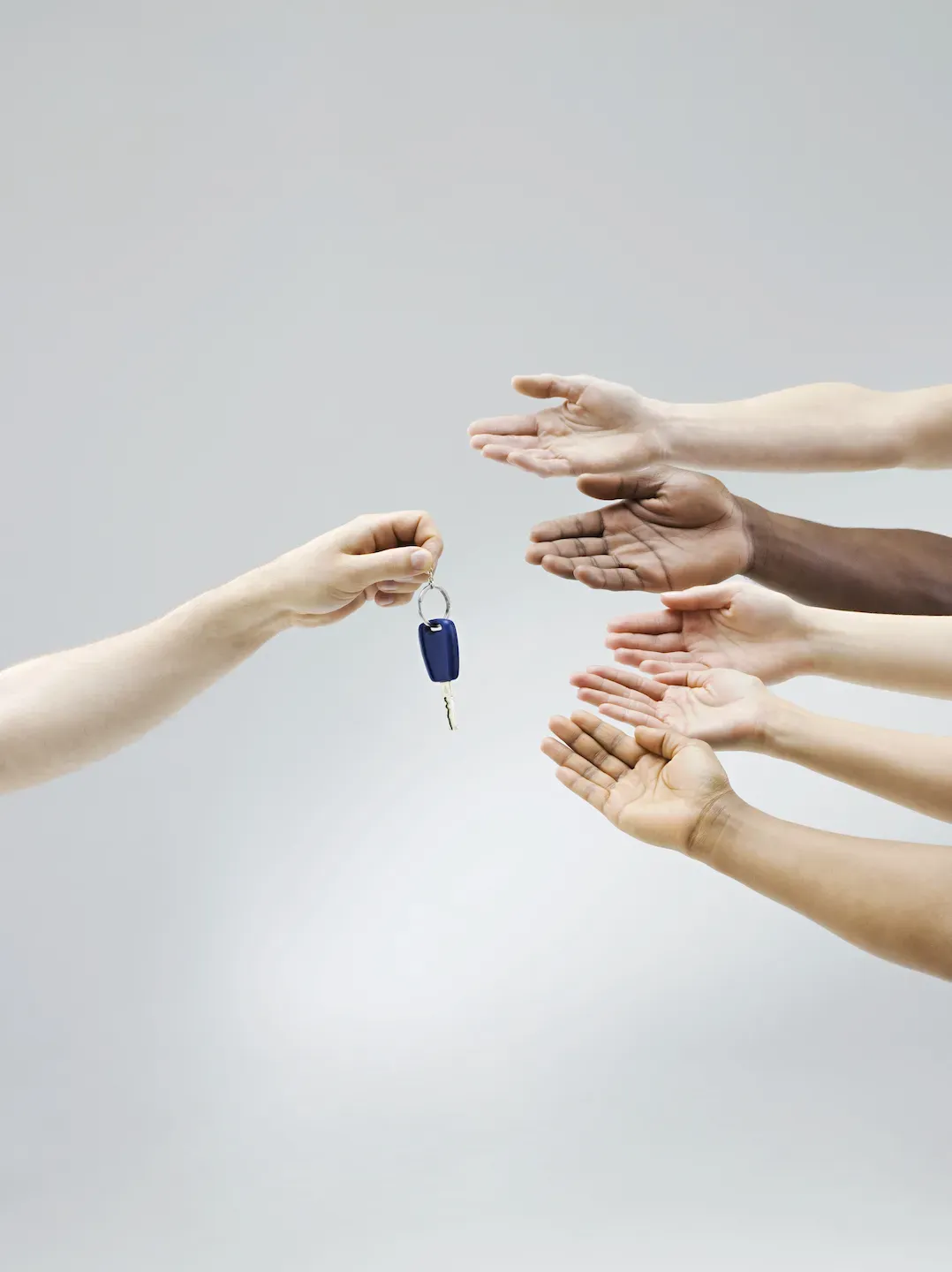 GettyImages-164836141.jpg Holding out car keys to a group of people
