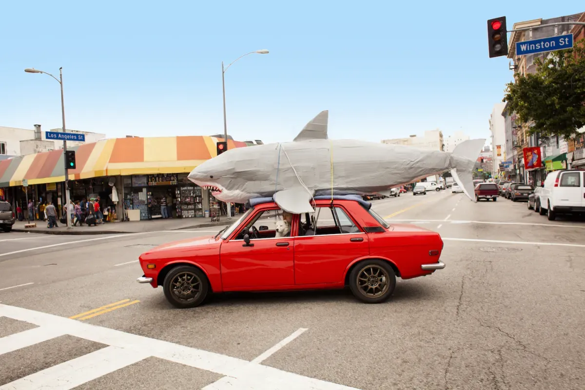 GettyImages-185866834.jpg Red car driving with a shark on top