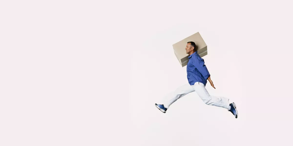 Man jumping with a box