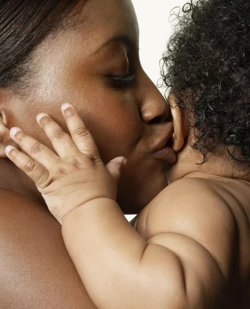 GettyImages-200356481-001.jpg Mother kissing her baby