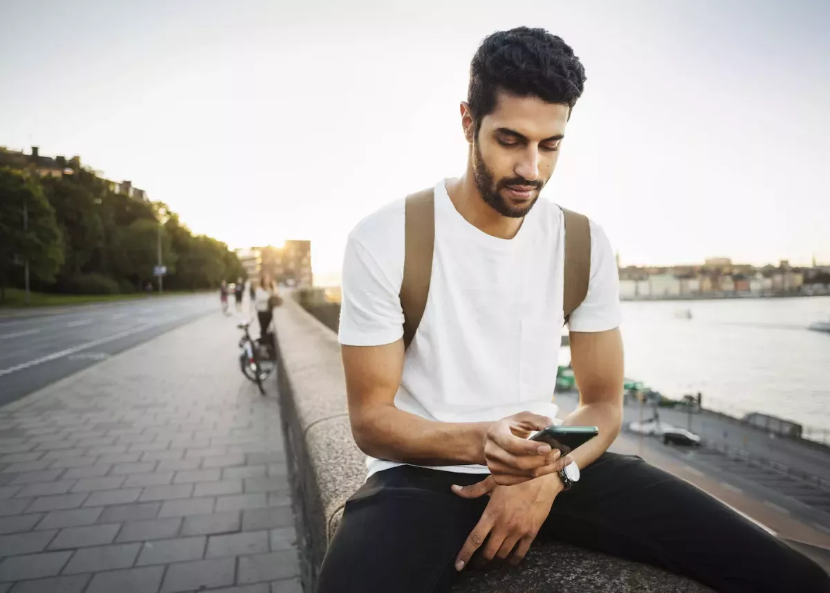 GettyImages-605380759.jpg Man checking his phone