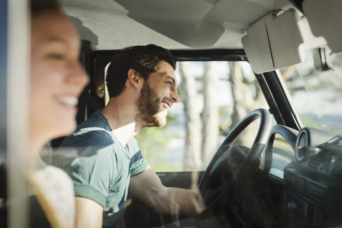 GettyImages-605381283.jpg Couple driving and laughing