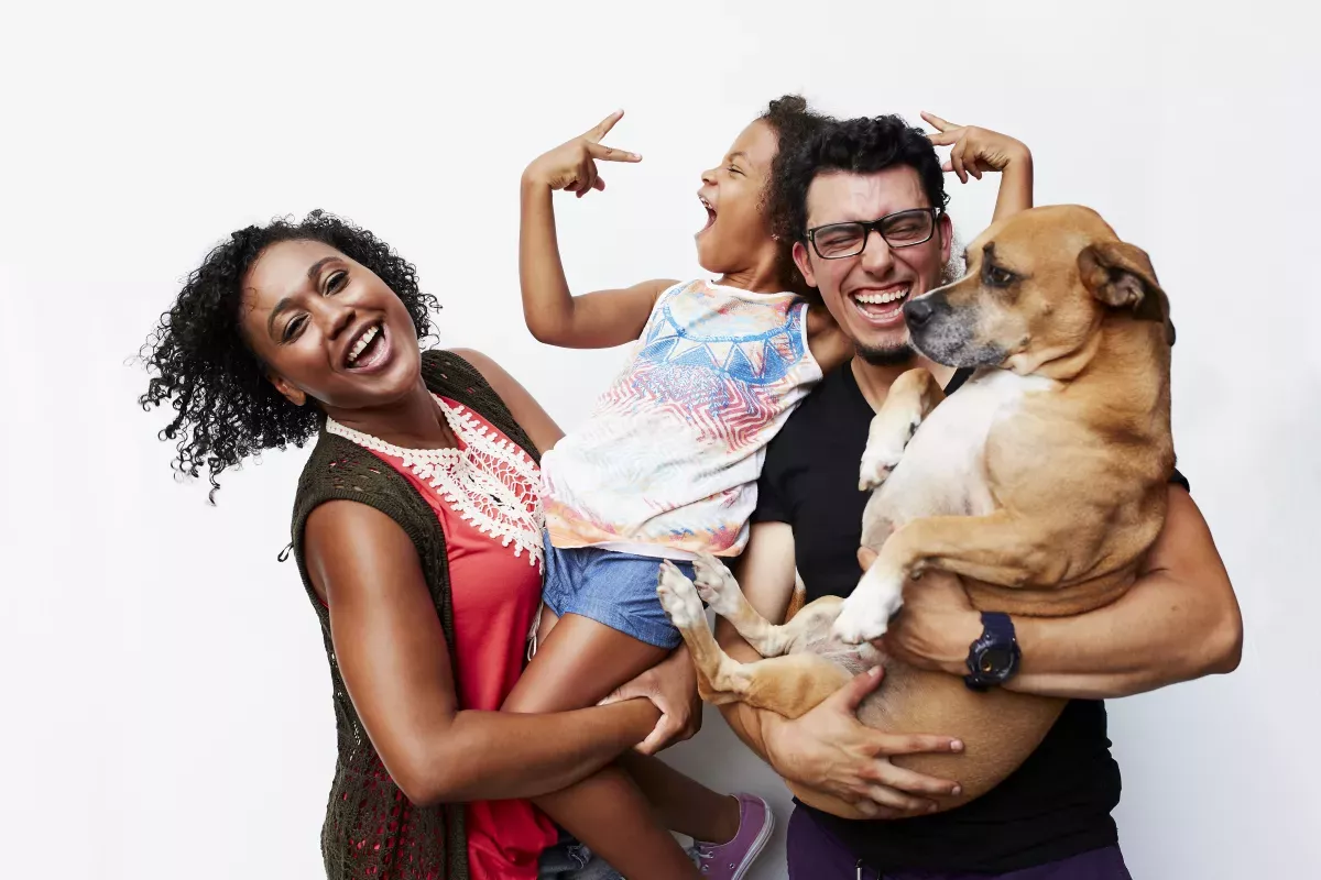 GettyImages-699084105 copy.jpg_UltraFICO Score Energetic young family portrait mother holding daughter and father holding puppy
