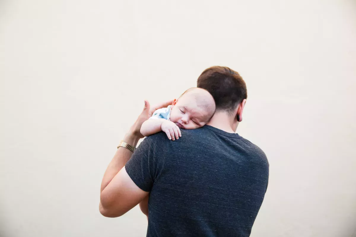 GettyImages-814191862 copy.jpg Man holding a newborn baby