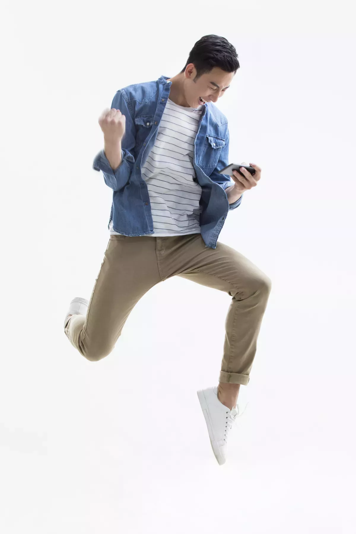 GettyImages-898205342.jpg man leaping with joy looking at cell phone