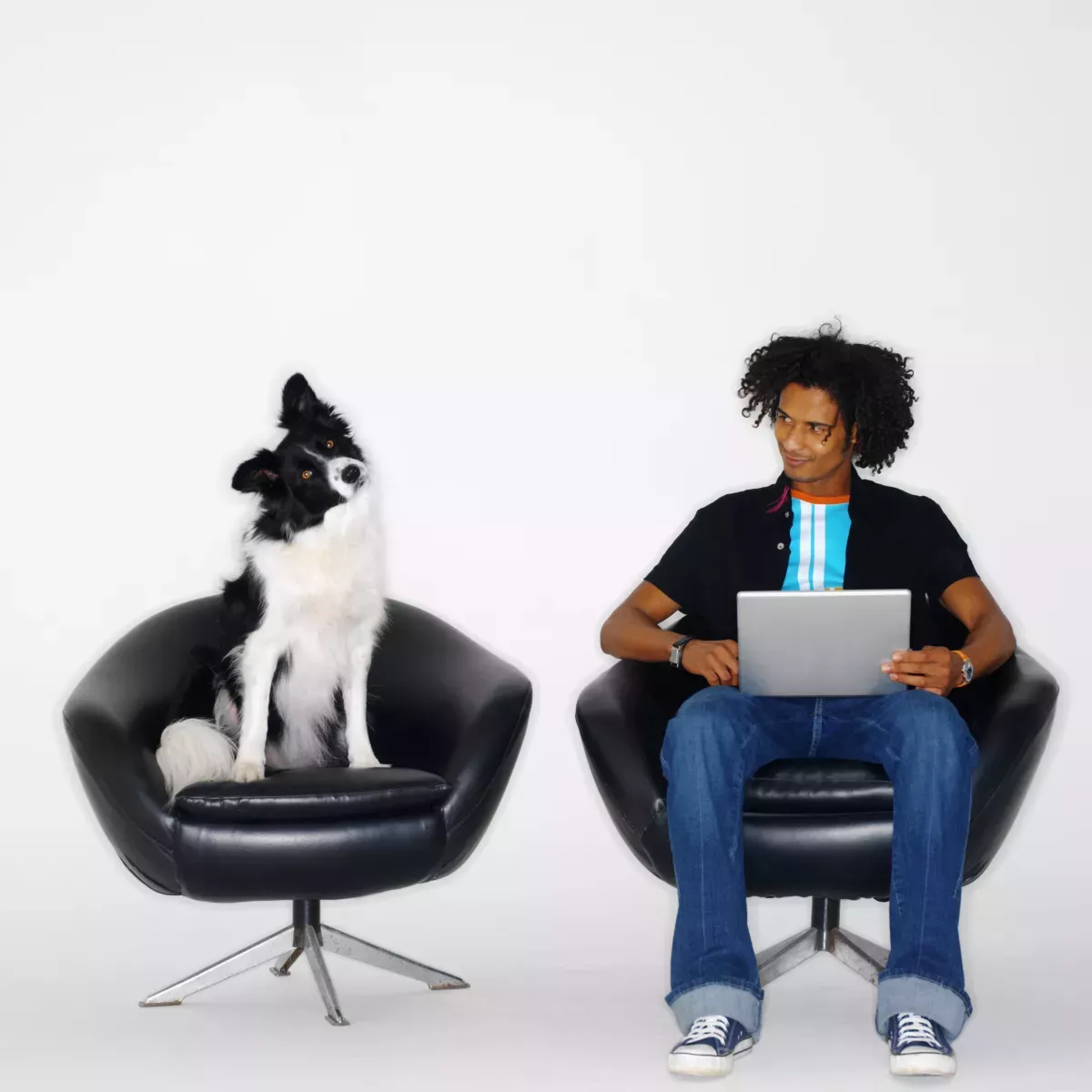 GettyImages-stk203129rke.jpg man and dog sitting on chairs