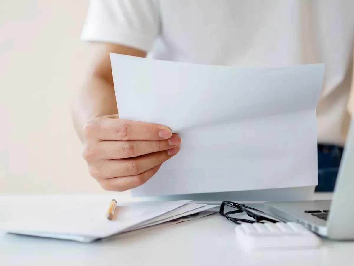 AdobeStock_327359253.jpeg Person reading the mail
