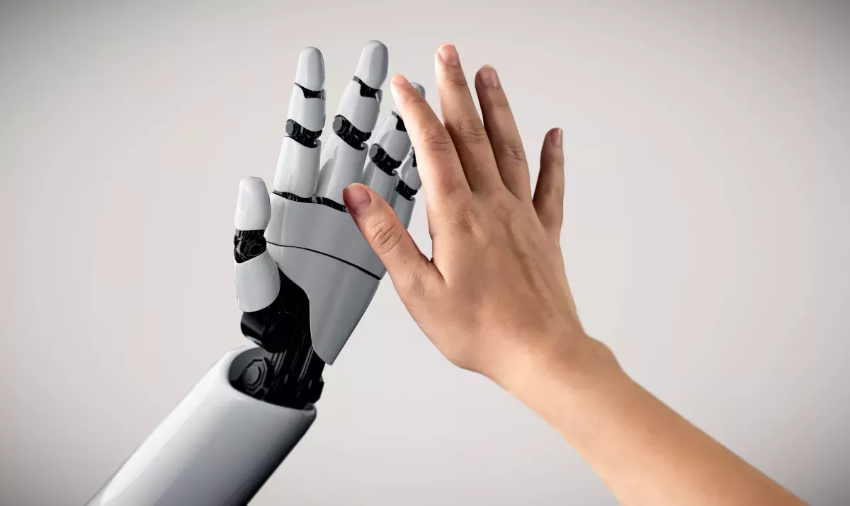 AdobeStock_328896336.jpeg Human and robot giving a high five