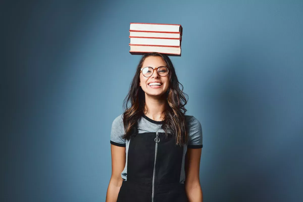 GettyImages-1141602094.jpg Woman balancing books on her head