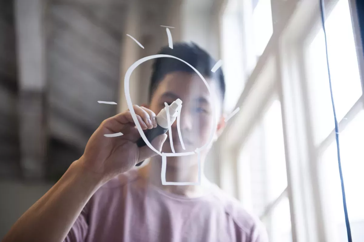 GettyImages-1141930832.jpg Man drawing a lightbulb with a marker