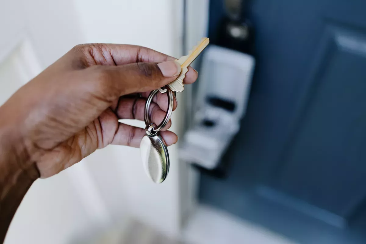 Person opening the door of a home