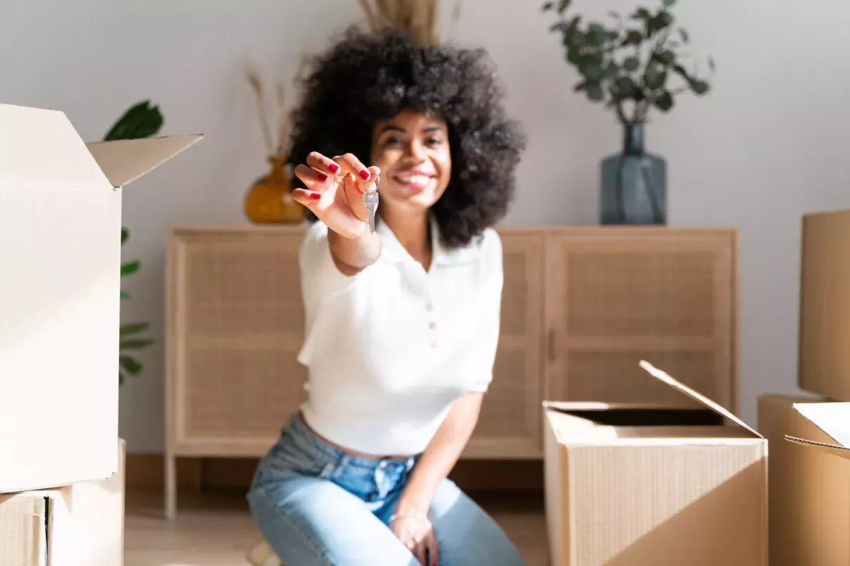 GettyImages-1425179876.jpg Woman unpacking boxes in her new home