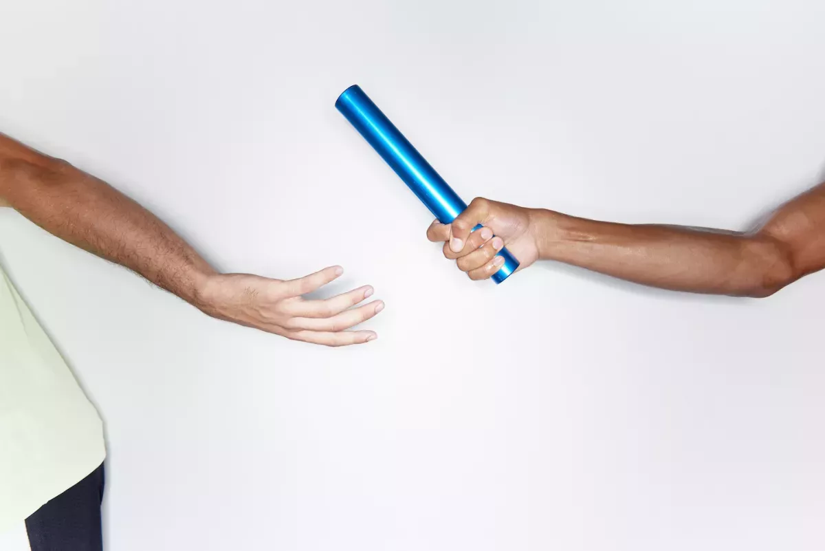 People running and passing a baton