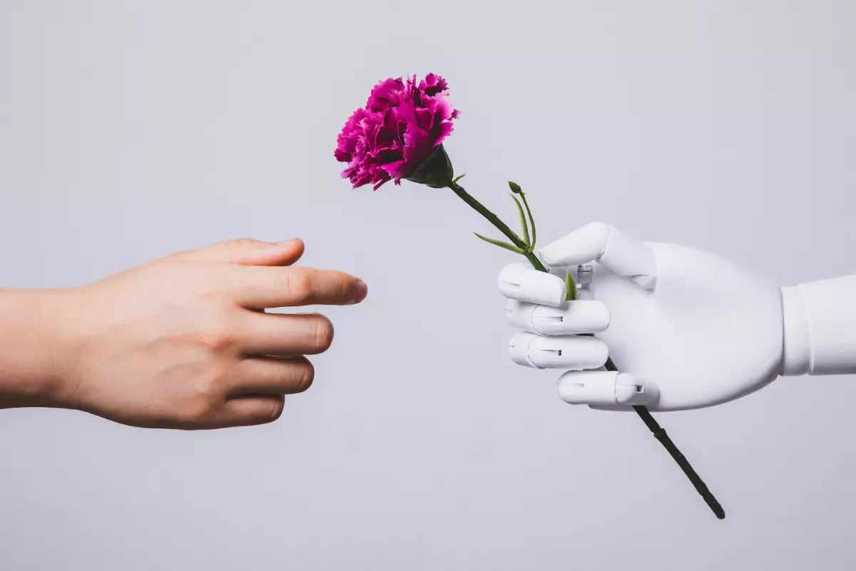 GettyImages-1256204331.jpg Person receiving a flower from a robot