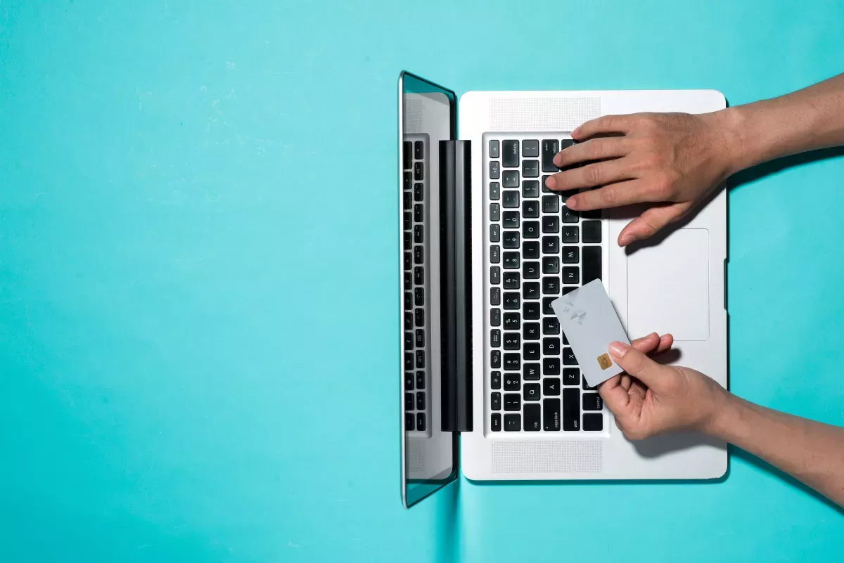 man-using-card-computer.jpeg Man using credit card on computer