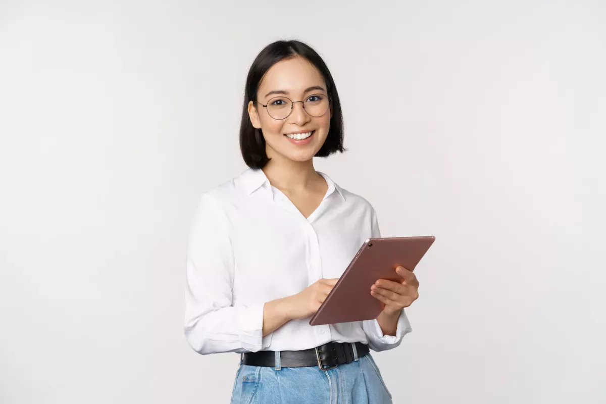 AdobeStock_486663253.jpeg smiling woman using tablet