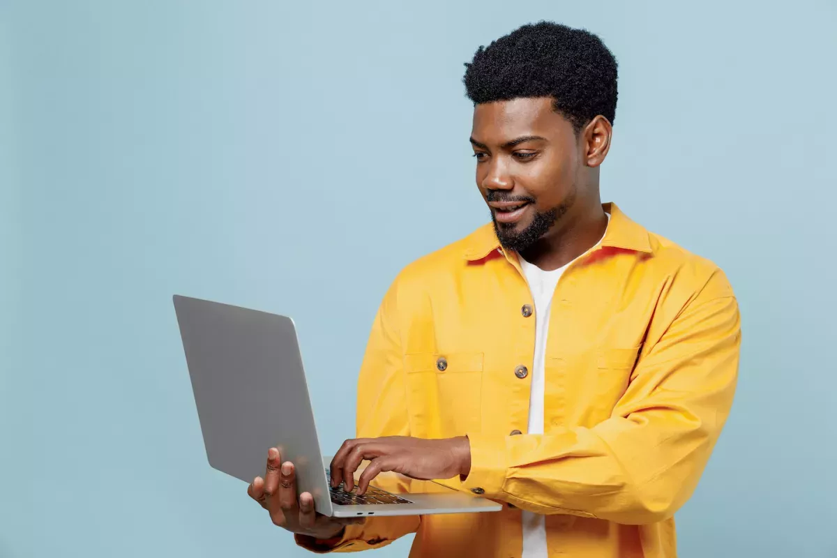 AdobeStock_496069431.jpeg man holding laptop