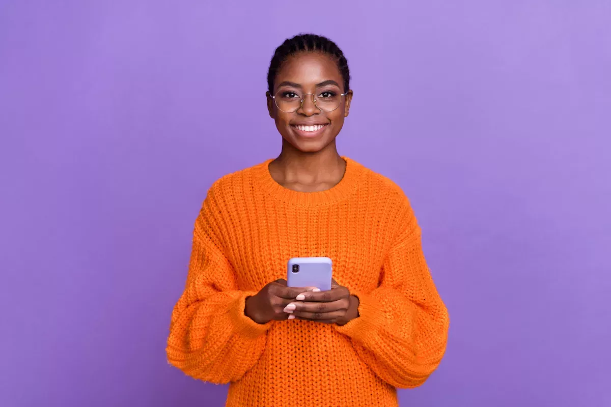 AdobeStock_502960819.jpeg happy person using cell phone