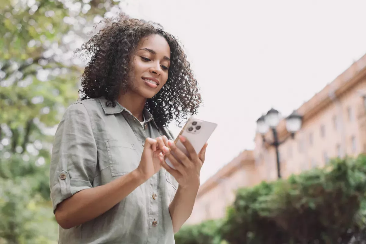 AdobeStock_547681761.jpeg woman looking at phone