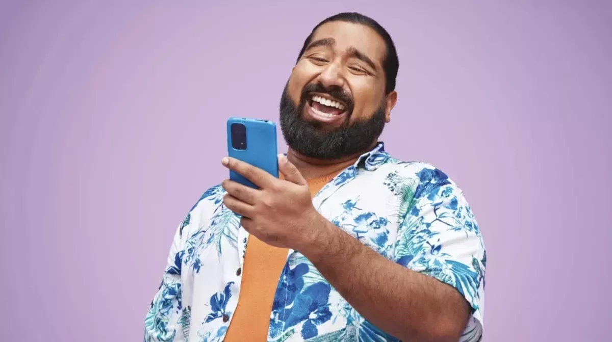 Trust Bank.png Man laughing and looking at a phone