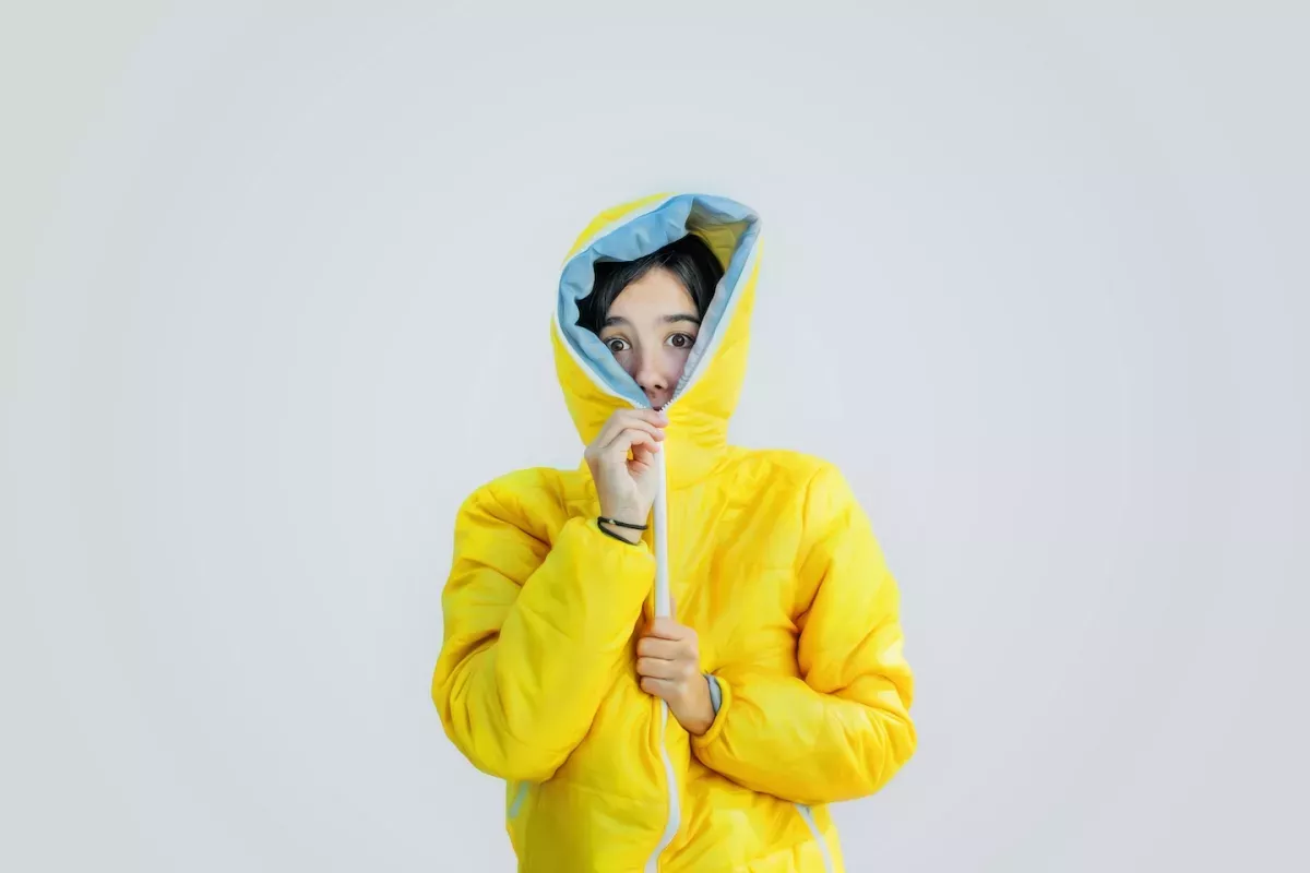 person zipping up jacket