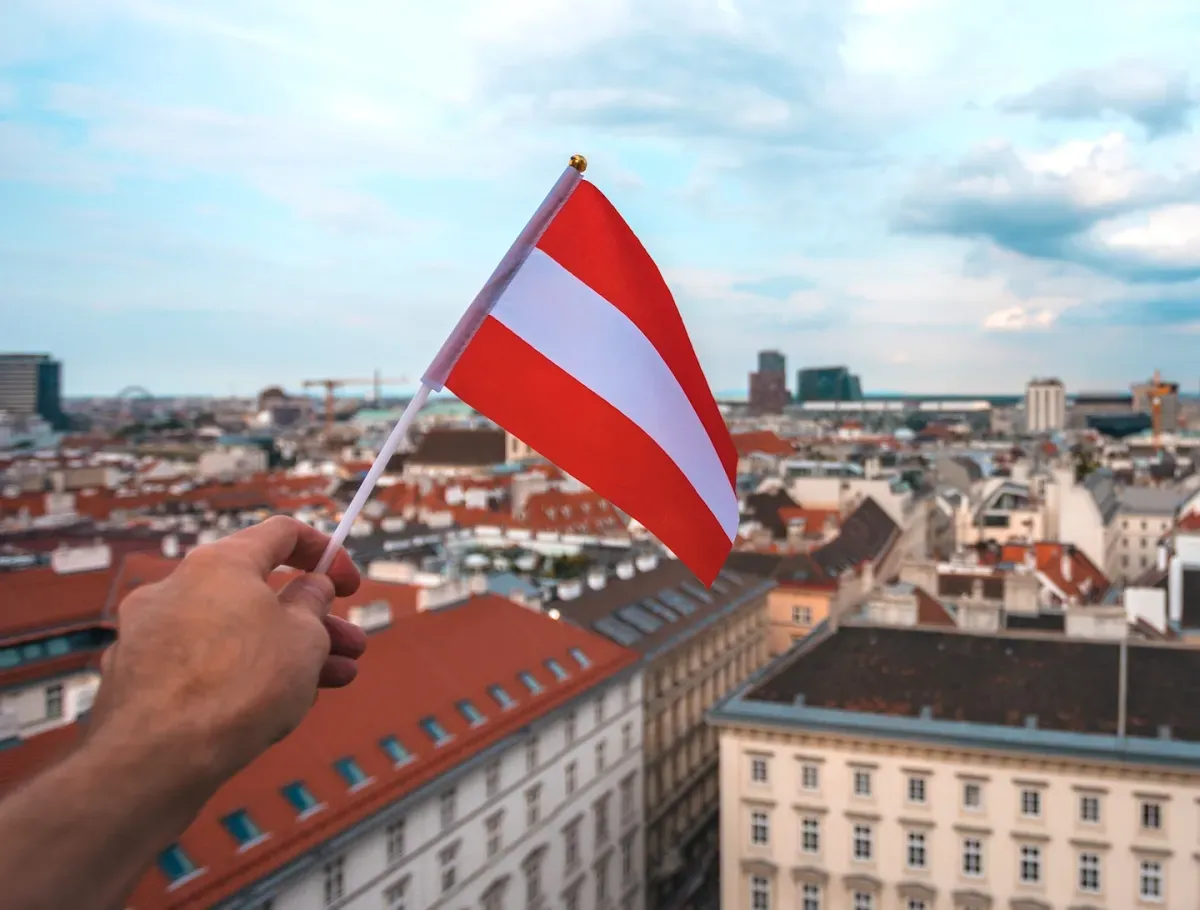 Hand holding Austria flag Hand holding Austria flag