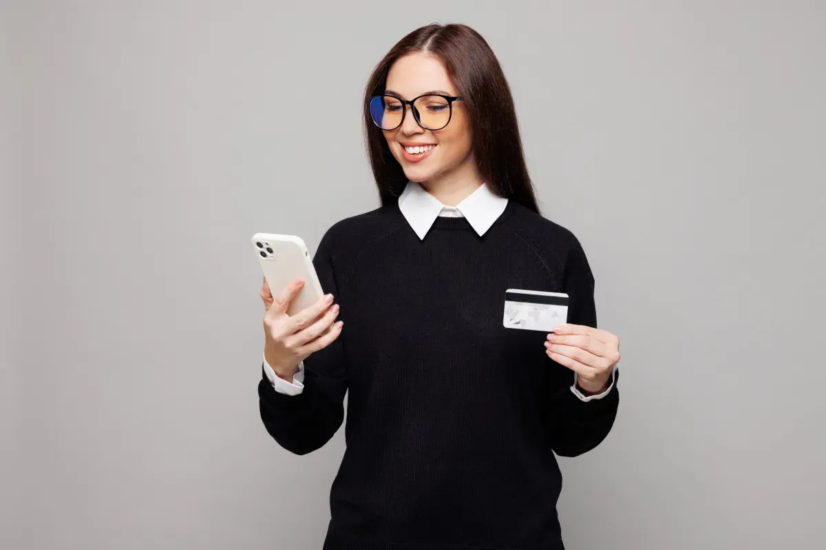 Person with phone and credit card