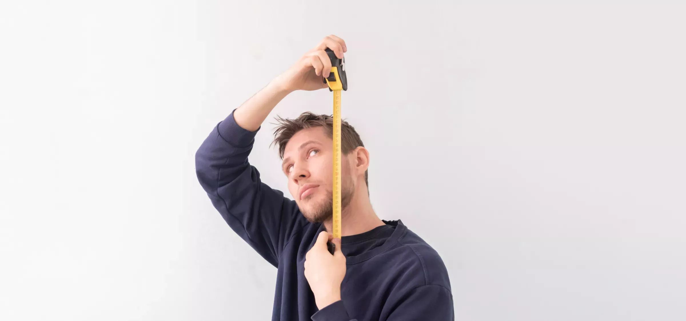 AdobeStock_418882180 1.png Man with tape measure