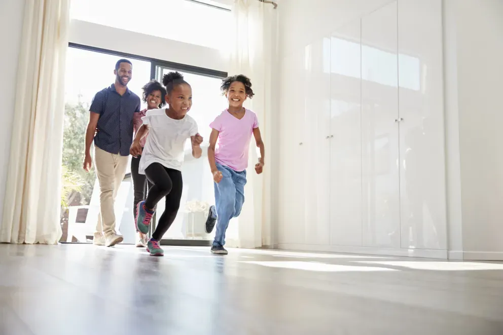 Happy family running into their new home