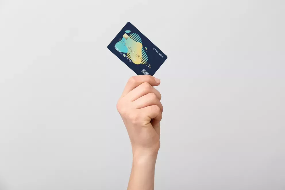 close up of person holding credit card close up of person holding credit card