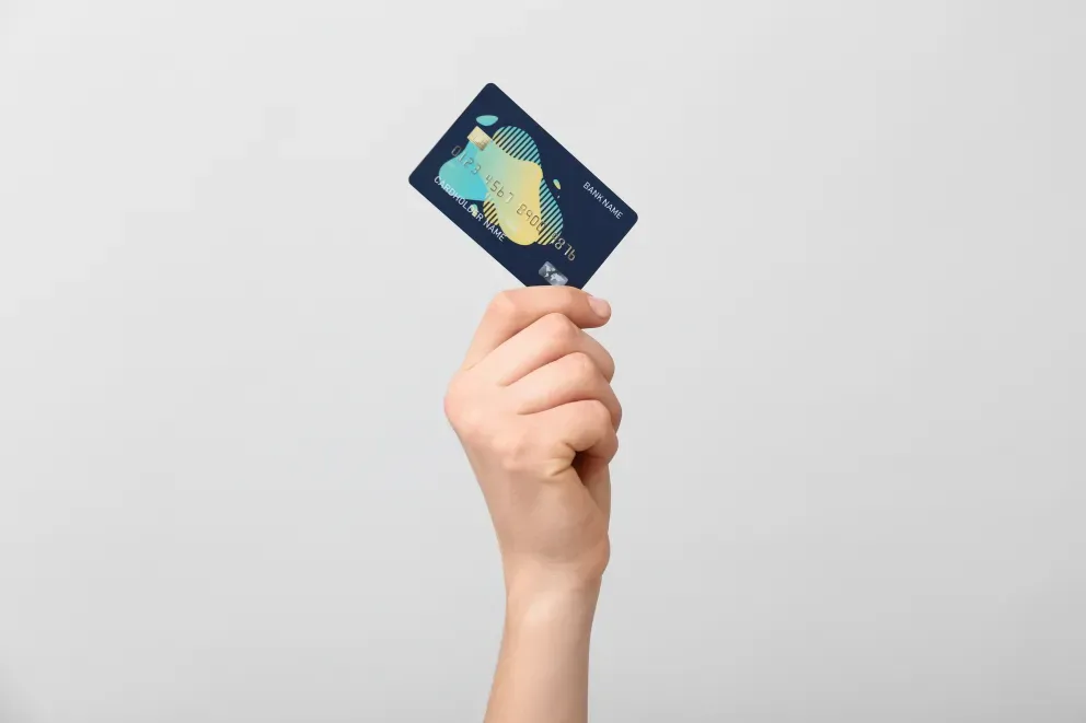 close up of person holding credit card