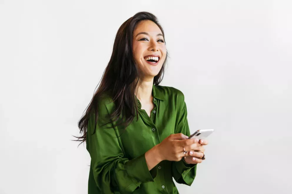 smiling woman using cell phone smiling woman using cell phone