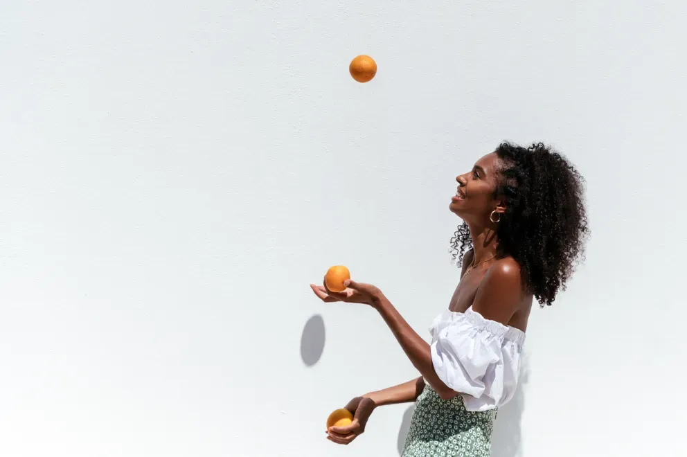 woman juggling orange woman juggling orange