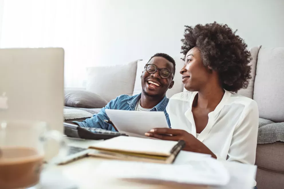 couple doing bills smiling
