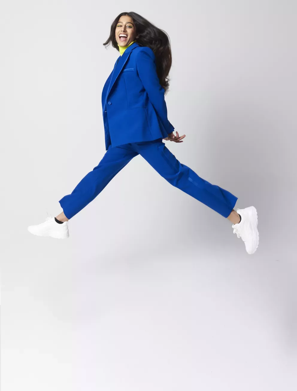 woman in business suit leaping