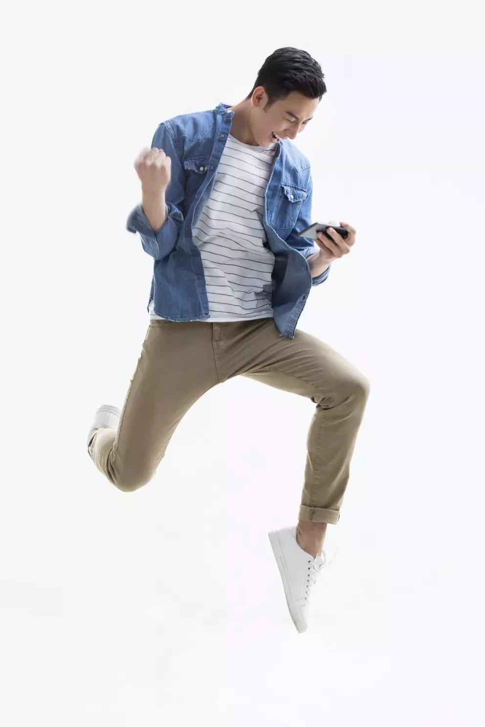 man leaping with joy looking at cell phone man leaping with joy looking at cell phone