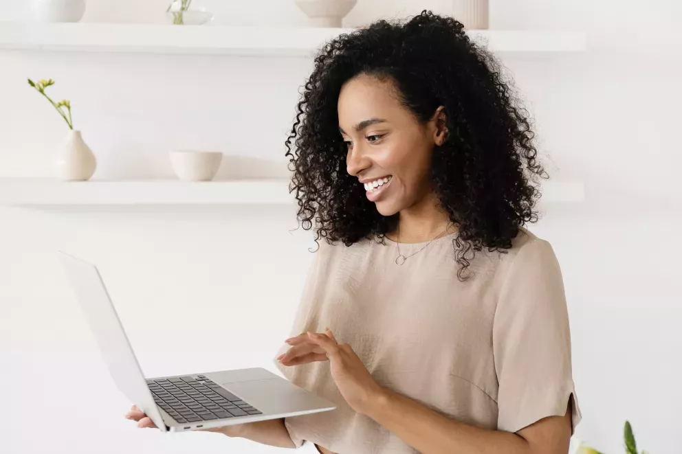 smiling woman using laptop smiling woman using laptop
