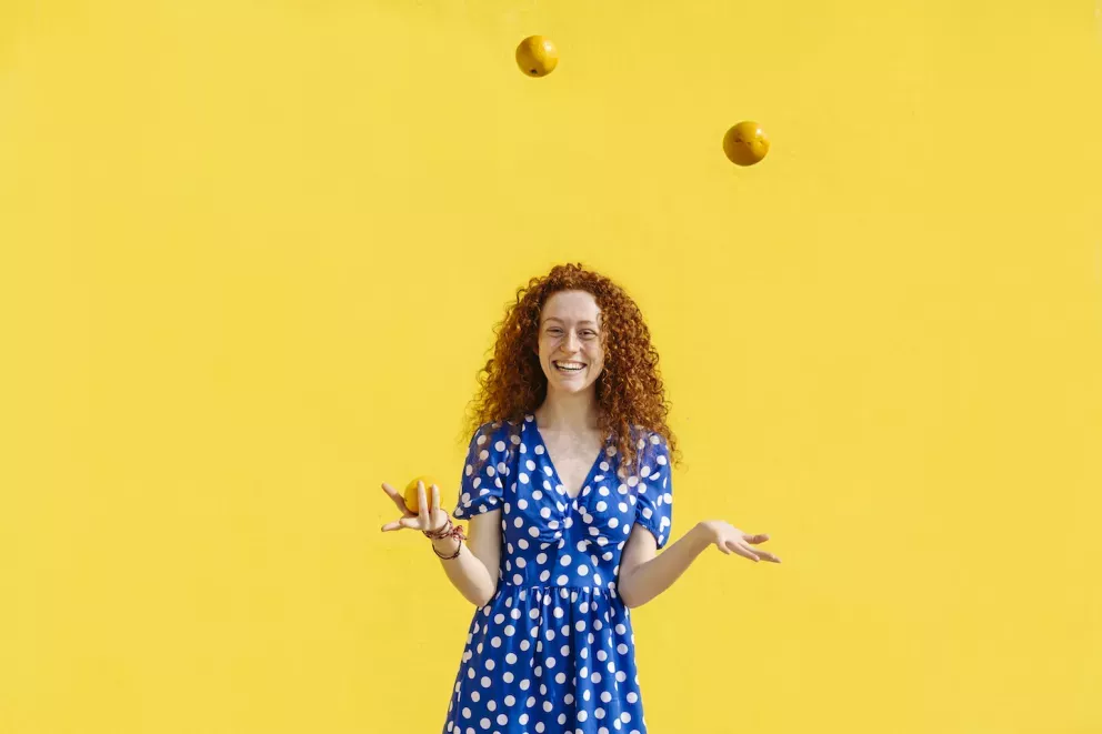 Woman juggling oranges Woman juggling oranges