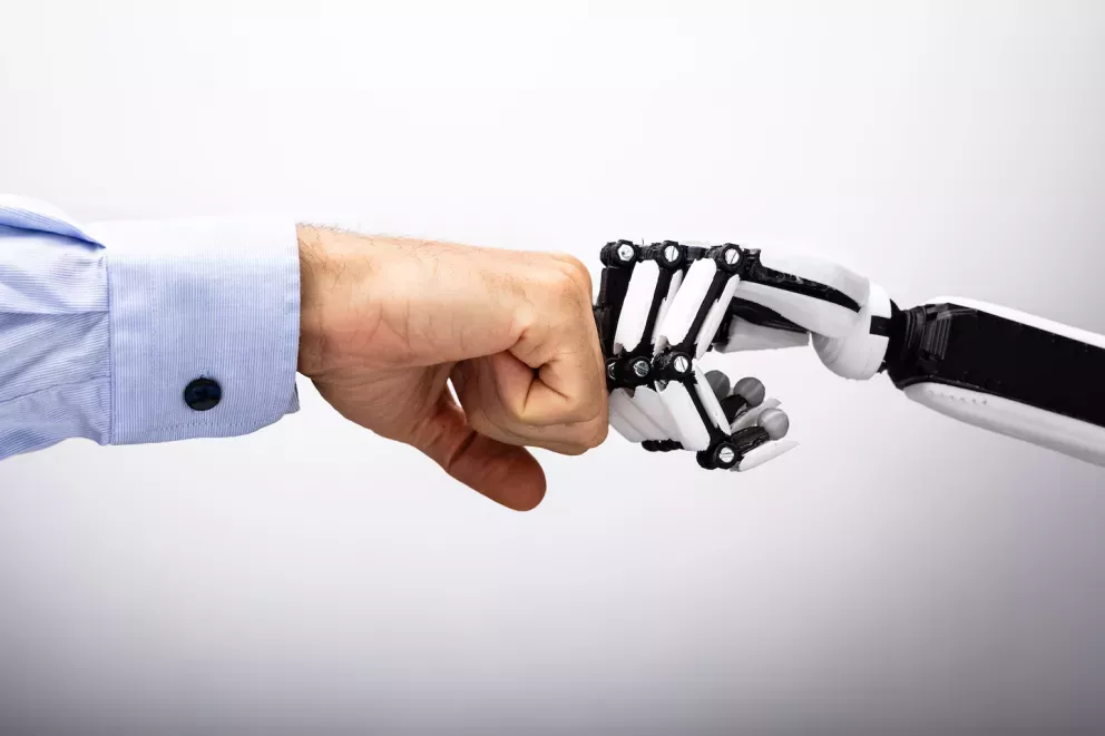human hand and robot hand bumping fists human hand and robot hand bumping fists