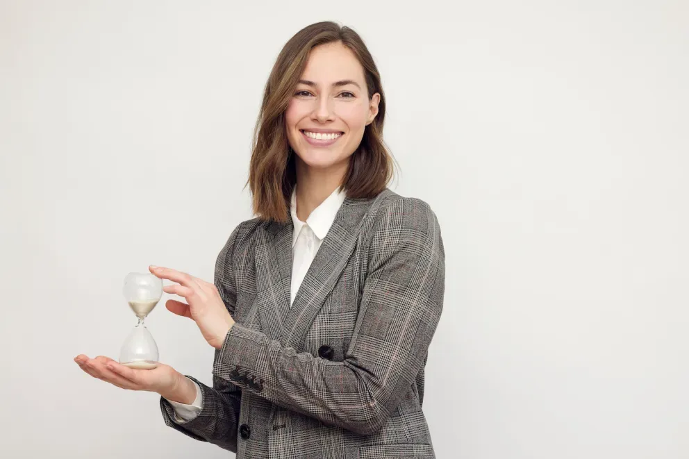 Business woman holding sand timer Business woman holding sand timer