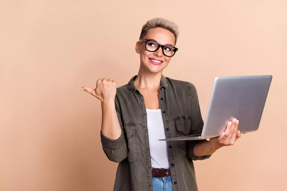 smiling person holding a laptop smiling person holding a laptop