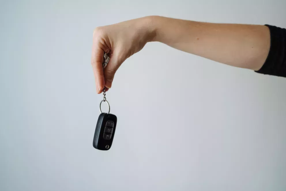 Person holding keys Person holding keys