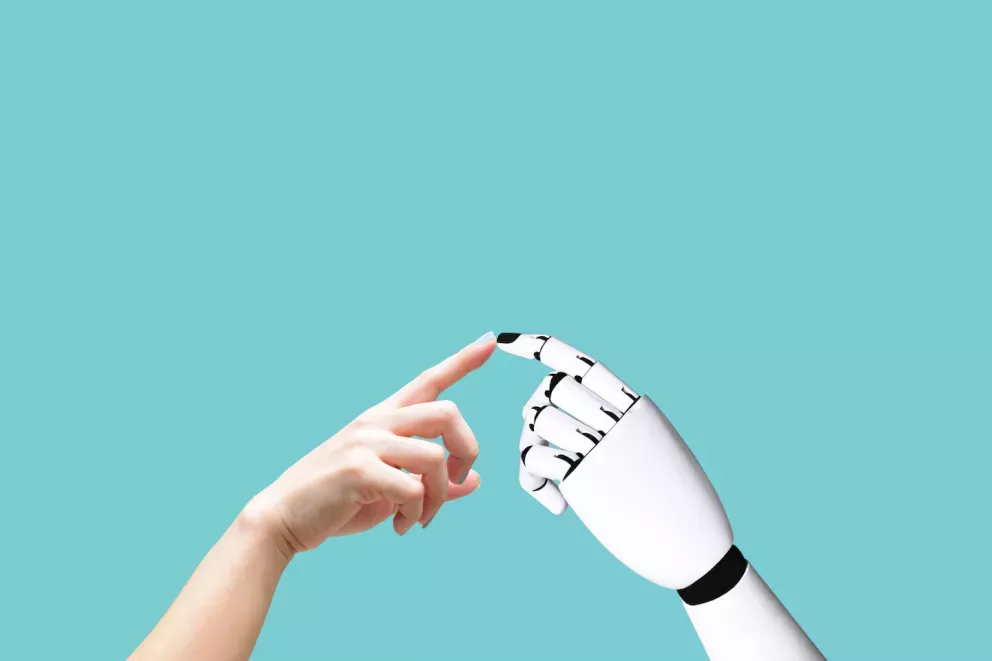 Person and robot touching fingers