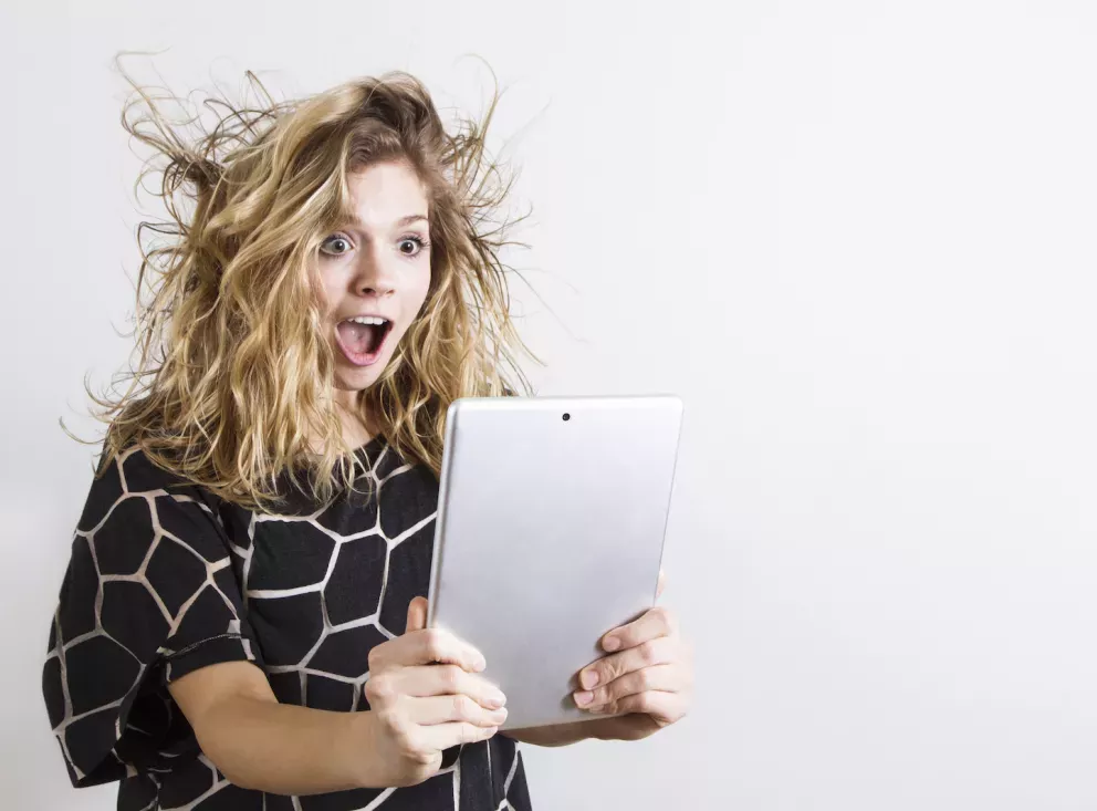 Happy woman looking at a tablet