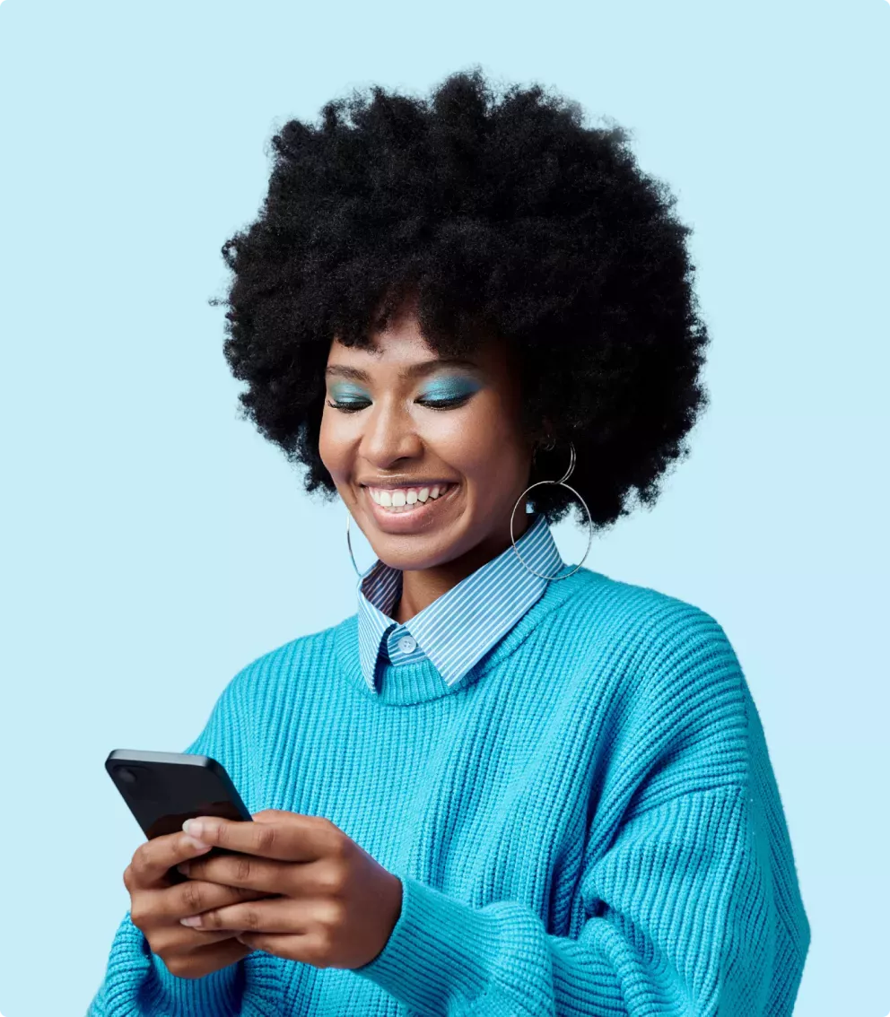 Woman smiling looking at a phone Woman smiling looking at a phone