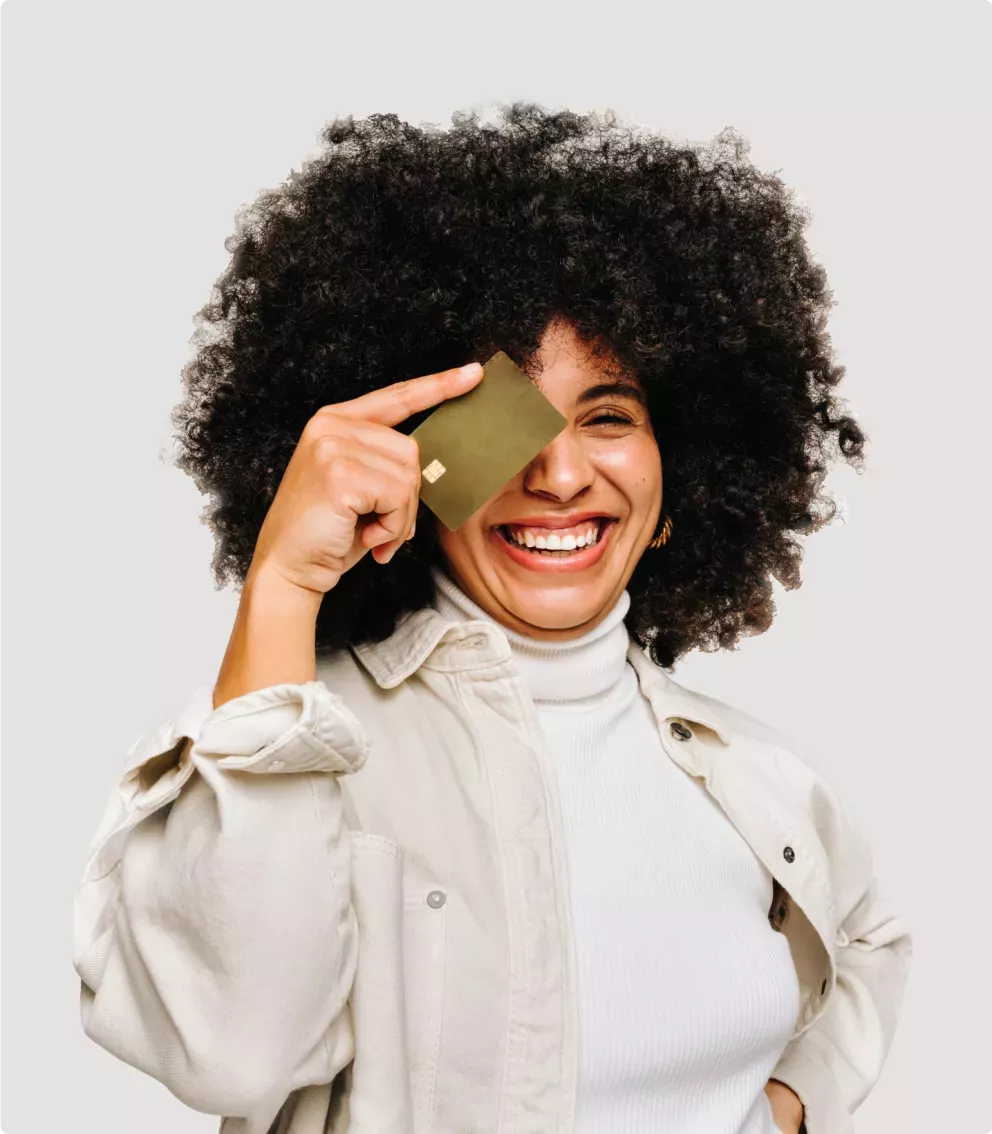 Woman holding a credit card over her eye Woman holding a credit card over her eye