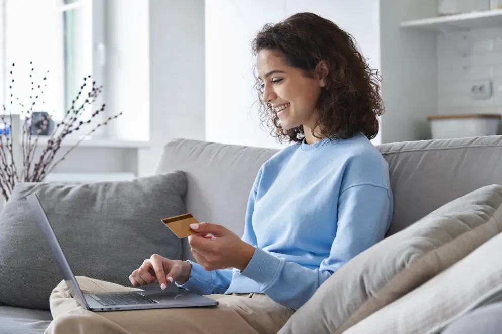 Woman with card on laptop